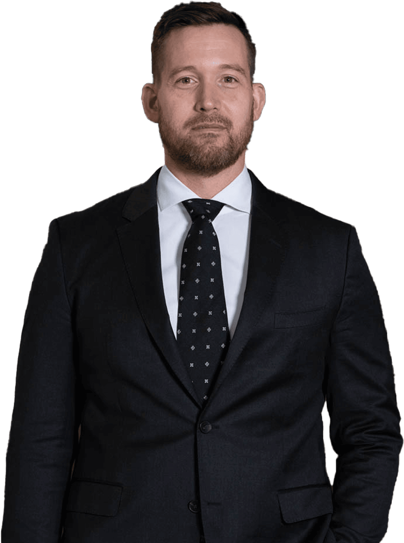 Man in a suit and tie standing against a plain white background.